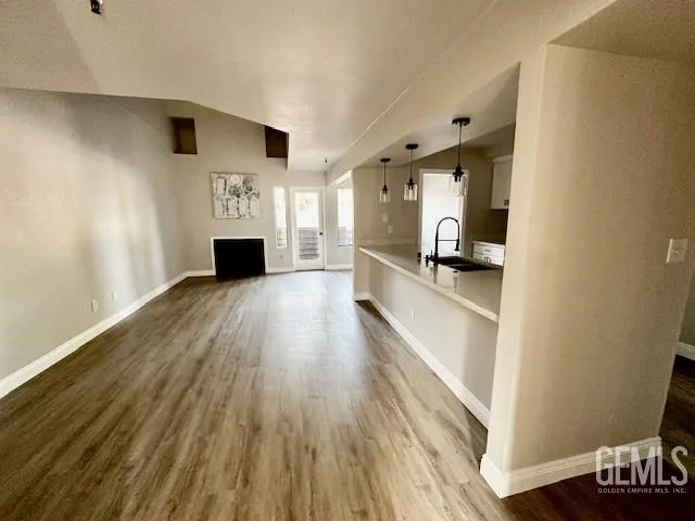 a view of a hallway with wooden floor and a fireplace