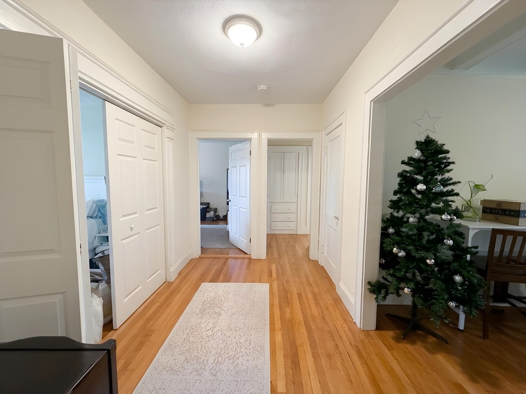 1472 Commonwealth Avenue, Unit 2 Boston, MA 02135 - Photo 14 of 16 a view of a hallway with wooden floor and entryway