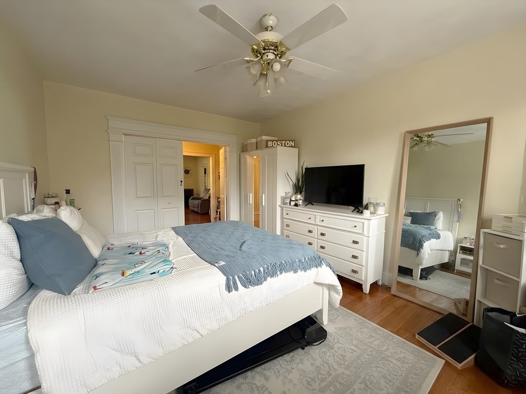 1472 Commonwealth Avenue, Unit 2 Boston, MA 02135 - Photo 15 of 16 a bedroom with a bed and a flat screen tv