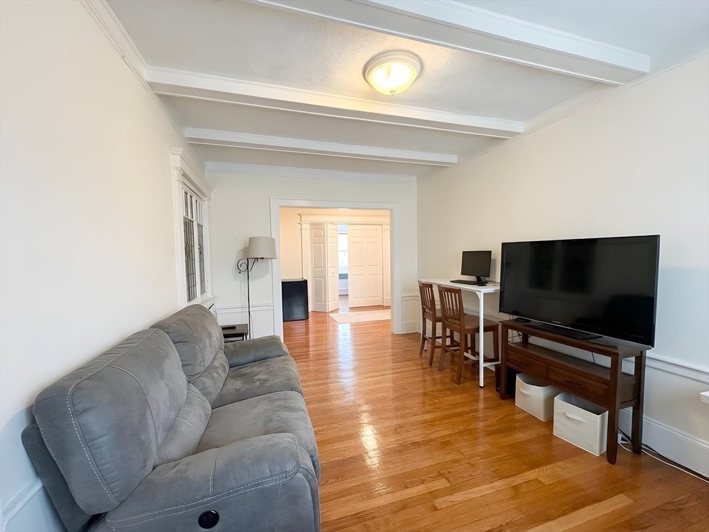 1472 Commonwealth Avenue, Unit 2 Boston, MA 02135 - Photo 3 of 16 a living room with furniture and a flat screen tv