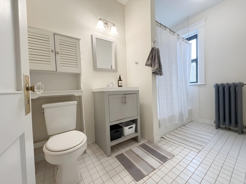 1472 Commonwealth Avenue, Unit 2 Boston, MA 02135 - Photo 4 of 16 a bathroom with a sink a toilet and shower