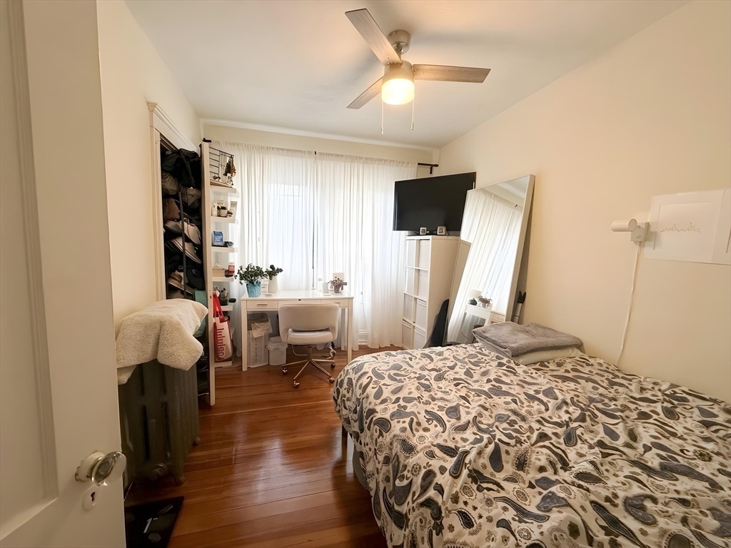 1472 Commonwealth Avenue, Unit 2 Boston, MA 02135 - Photo 6 of 16 a bedroom with a bed and a chandelier