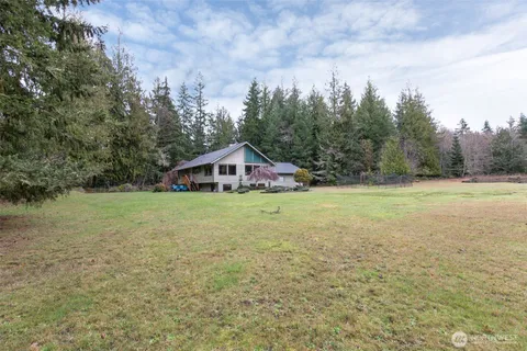 a view of an house with backyard space and garden