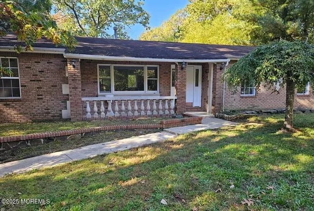 a view of a house with a yard porch and sitting area