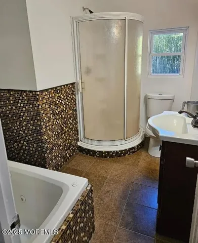 a bathroom with a bathtub and shower