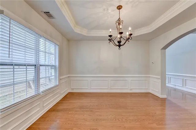 a kitchen with stainless steel appliances granite countertop a sink a stove and a wooden floors