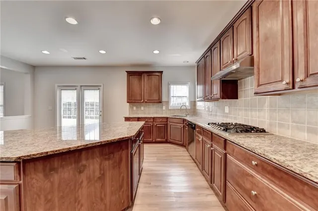 a kitchen with granite countertop cabinets and black stainless steel appliances