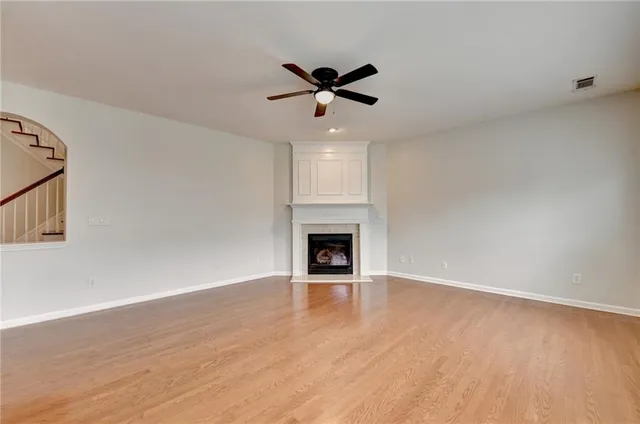a view of a kitchen and an empty room with a kitchen