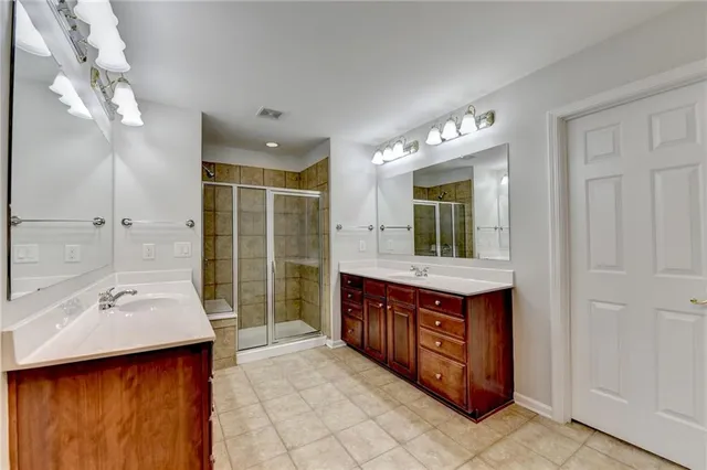 a bathroom with a sink double vanity and shower