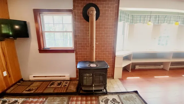 a view of empty room with window and ceiling fan