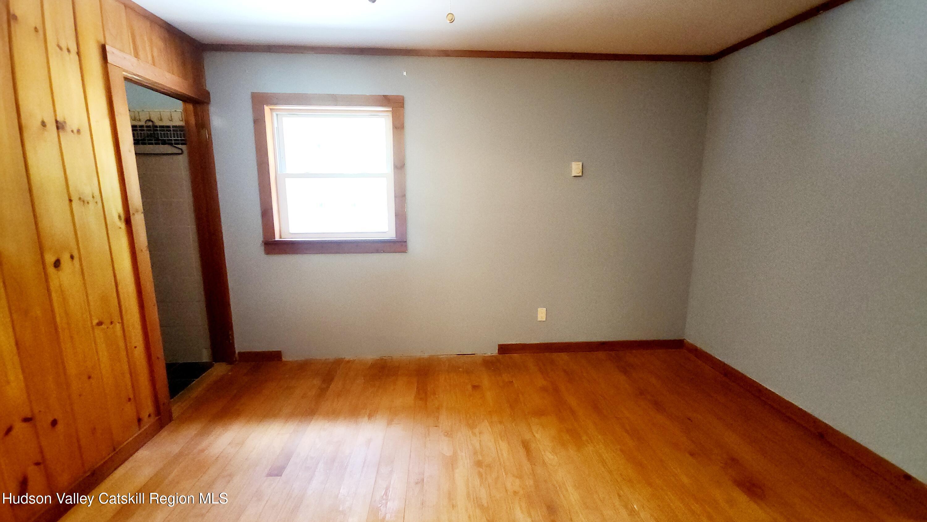 783 Broome Center Road Preston Hollow, NY 12469 - Photo 16 of 34 an empty room with wooden floor and windows