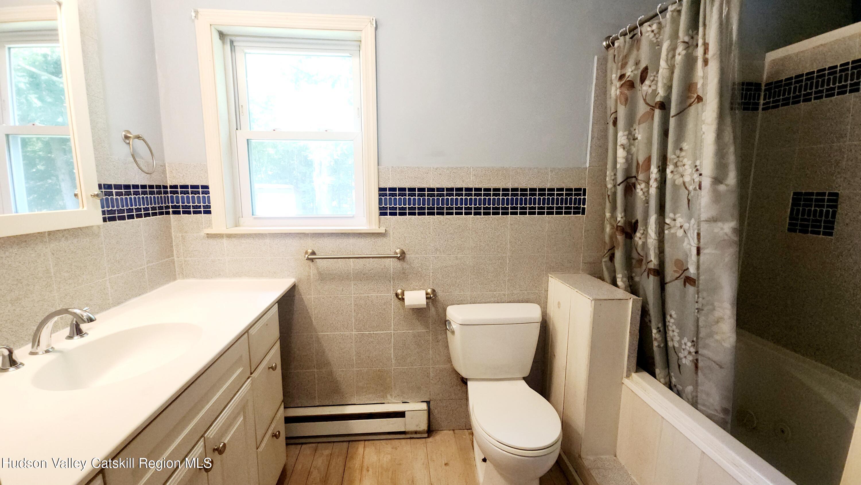 783 Broome Center Road Preston Hollow, NY 12469 - Photo 19 of 34 a bathroom with a sink toilet vanity and tub