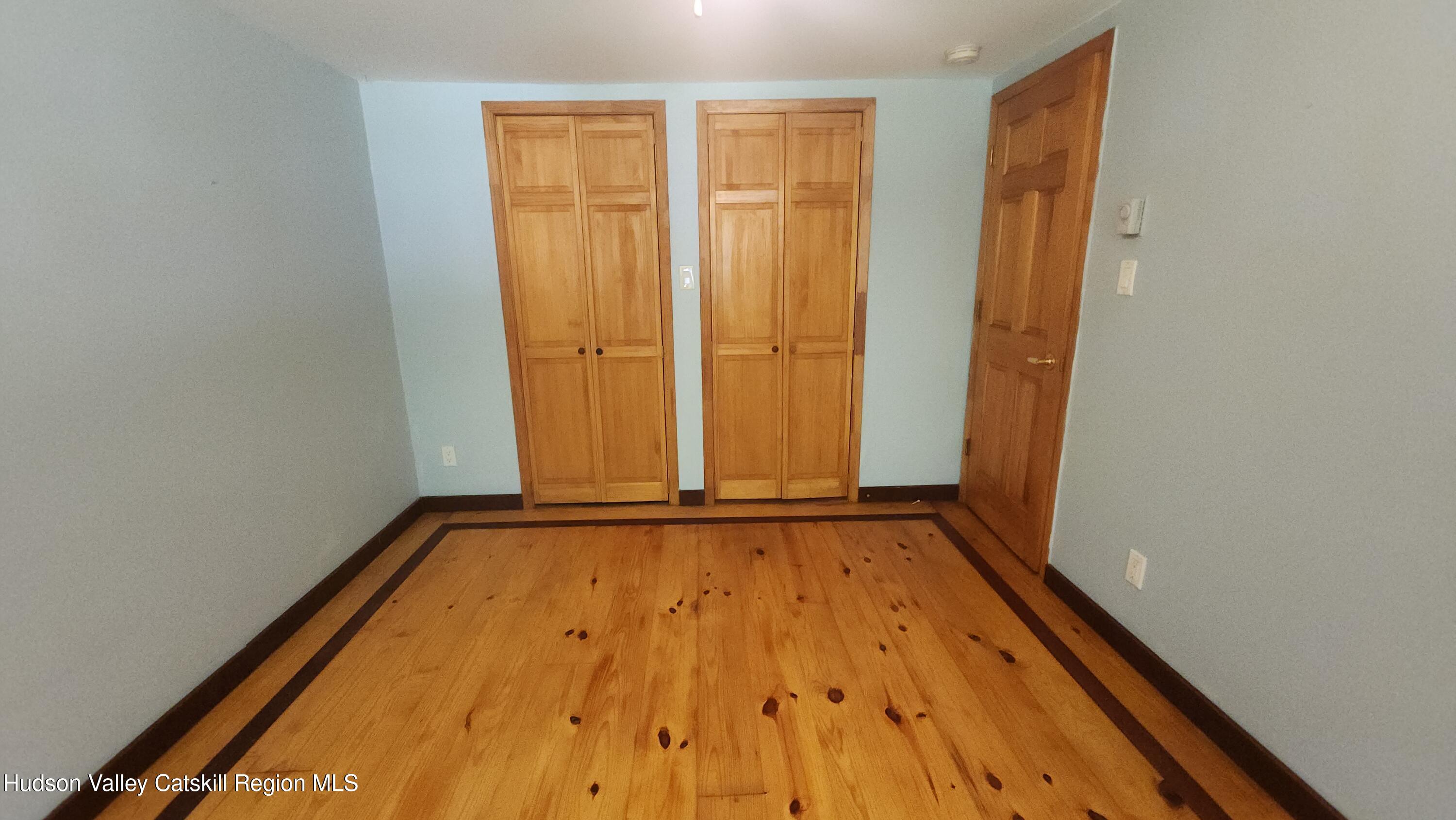 783 Broome Center Road Preston Hollow, NY 12469 - Photo 21 of 34 a view of an empty room with wooden floor and a window