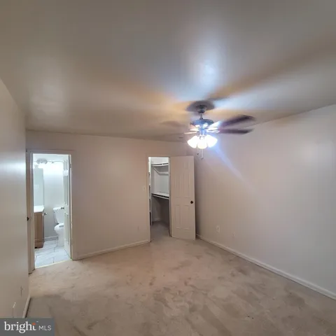 a view of a chandelier fan and closet