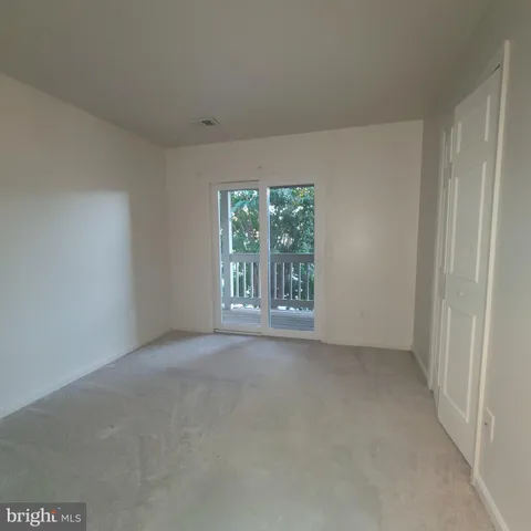 an empty room with windows and yard