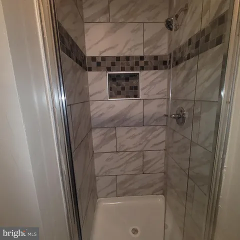 a bathroom with a shower and a sink