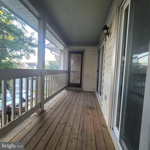 a view of a balcony with wooden floor