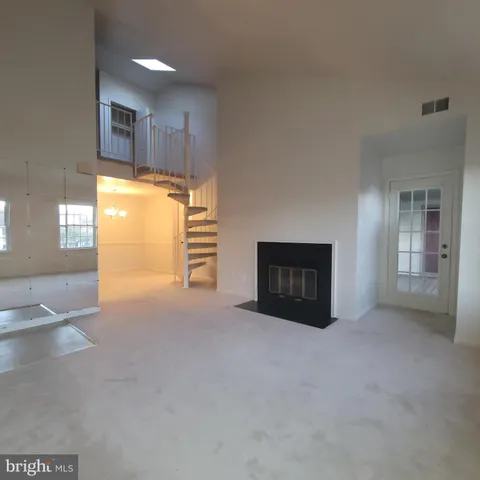 a view of an empty room with a kitchen