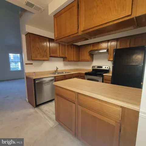 a kitchen with a stove and a refrigerator