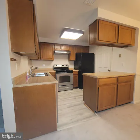 a kitchen with cabinets and steel stainless steel appliances