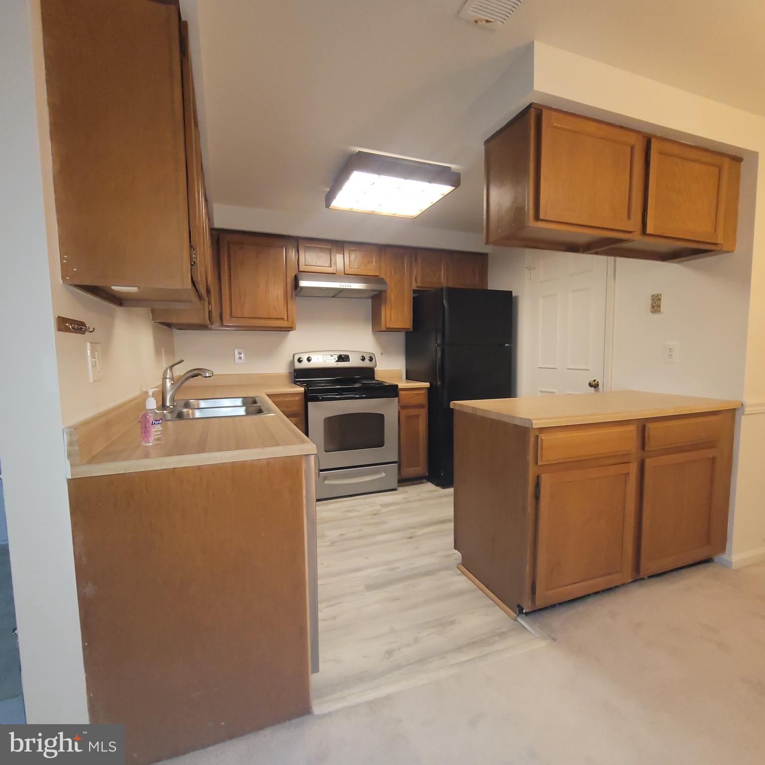 6903 B Sandra Marie Circle, Unit 6903B Alexandria, VA 22310 - Photo 9 of 21 a kitchen with cabinets and steel stainless steel appliances