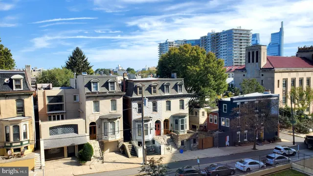 a room with a refrigerator a sink and cabinets