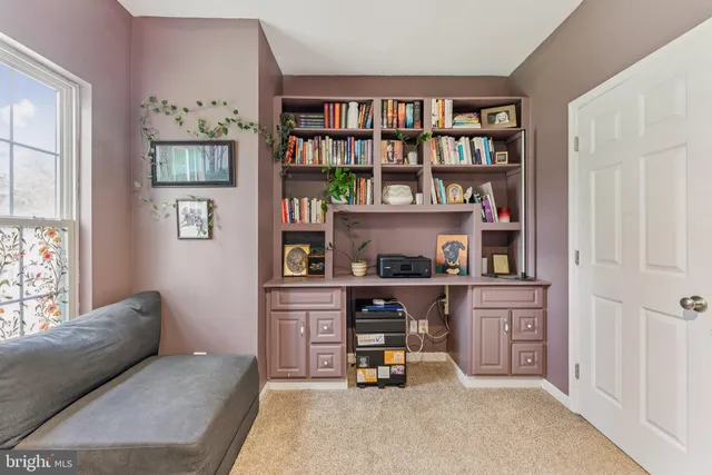 a living room with furniture cabinets and book shelf
