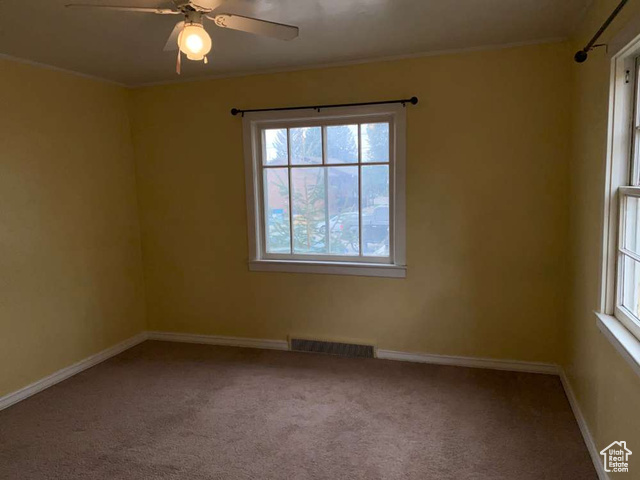 642 East 700 North Logan, UT 84321 - Photo 15 of 33 Carpeted spare room featuring ornamental molding and ceiling fan