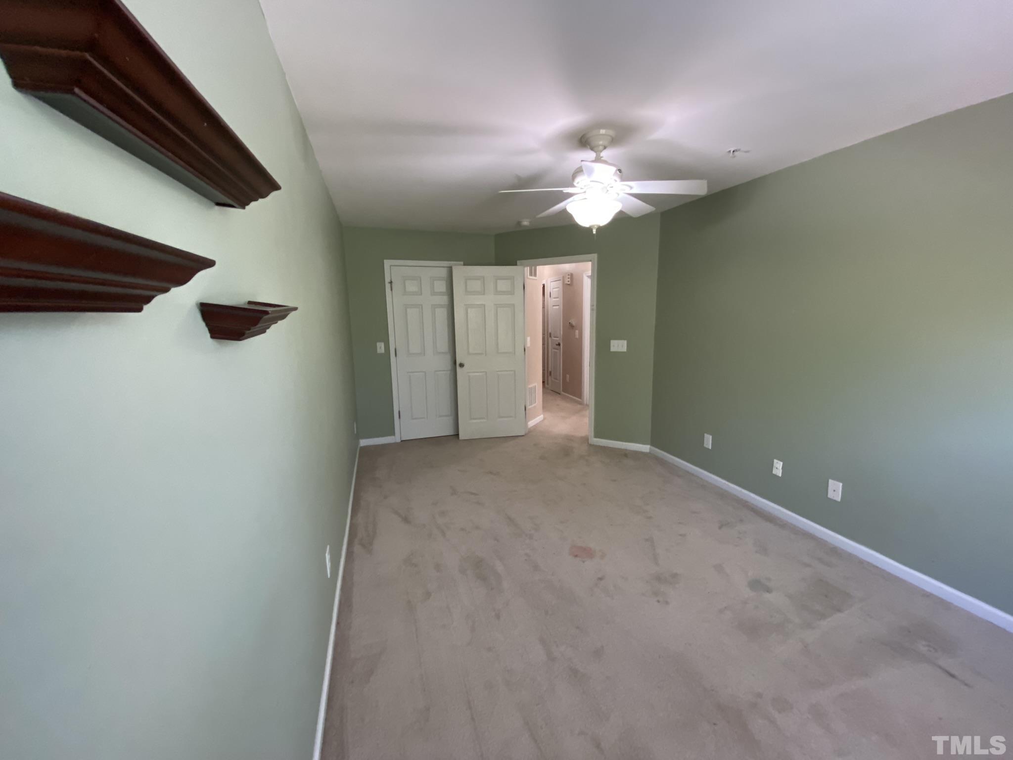 2220 Raven Road, Unit 101 Raleigh, NC 27614 - Photo 14 of 26 a view of an empty room with a chandelier fan