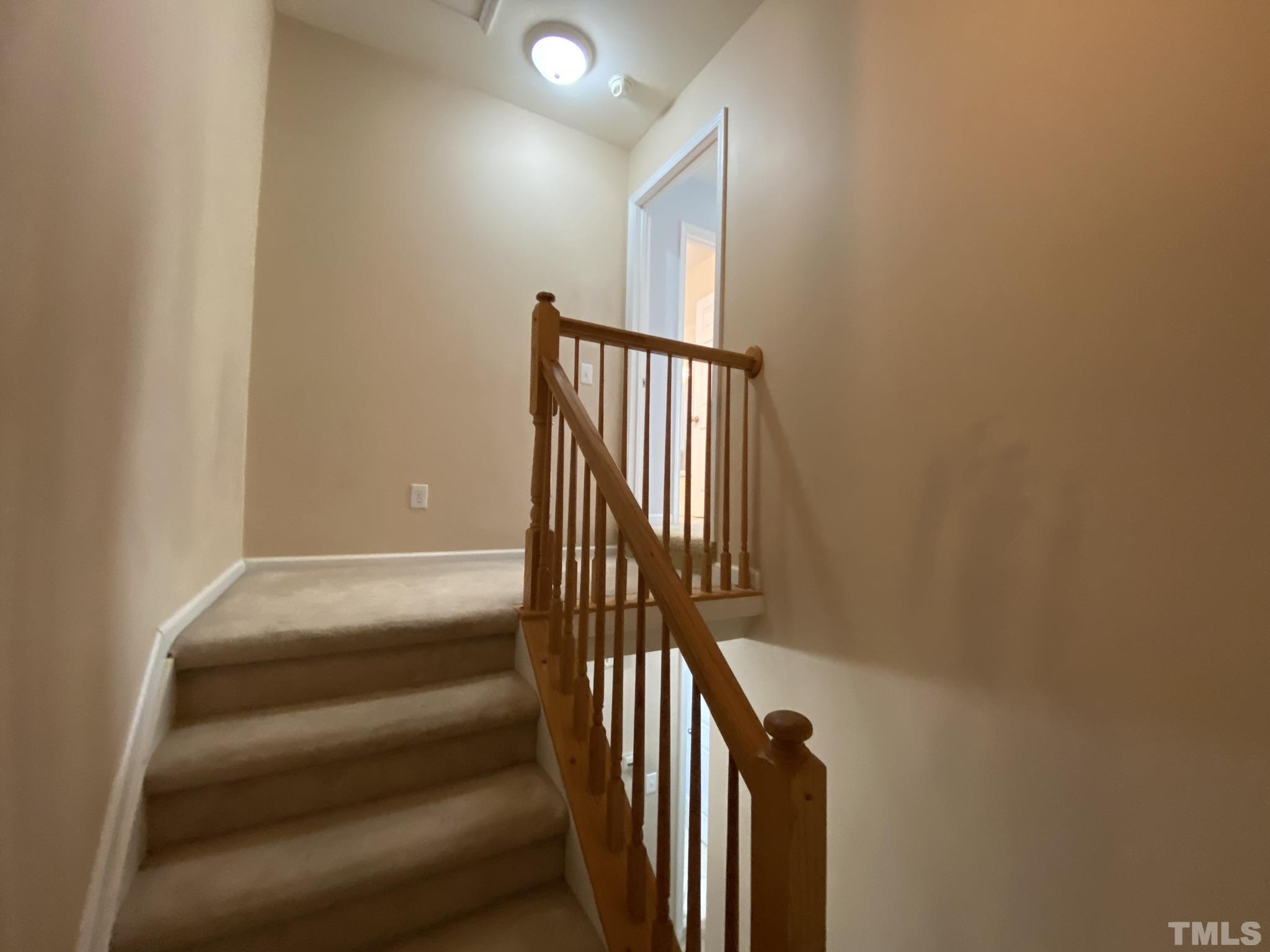 2220 Raven Road, Unit 101 Raleigh, NC 27614 - Photo 20 of 26 a view of staircase with railing and a window