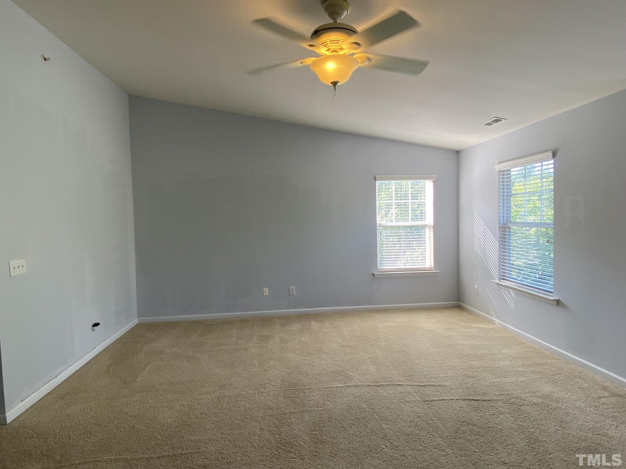 2220 Raven Road, Unit 101 Raleigh, NC 27614 - Photo 21 of 26 an empty room with a window and chandelier fan