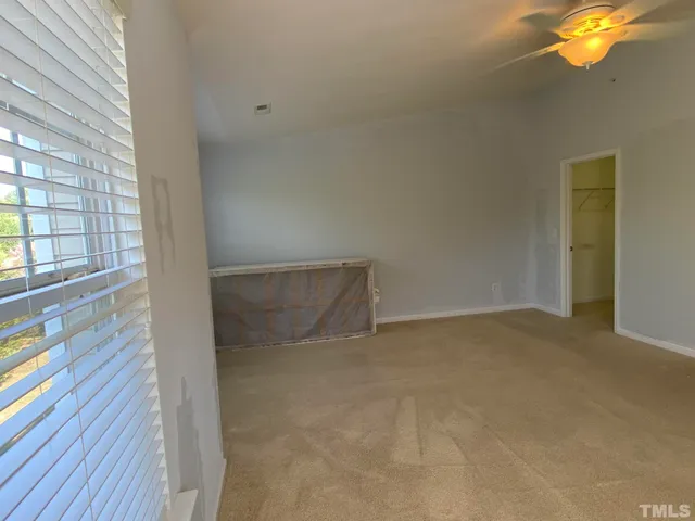 a view of an empty room and wooden floor