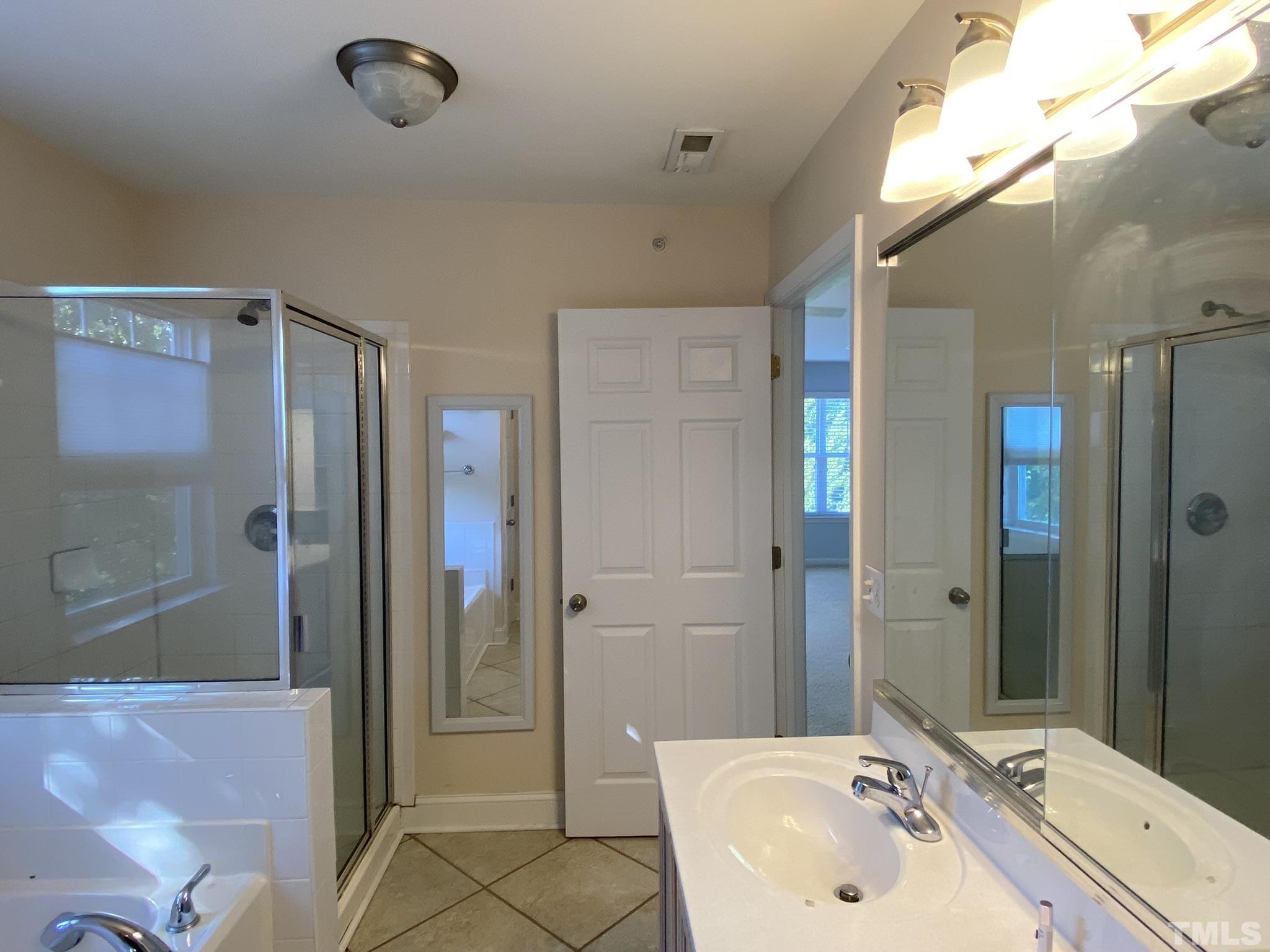 2220 Raven Road, Unit 101 Raleigh, NC 27614 - Photo 24 of 26 a bathroom with a sink mirror and shower