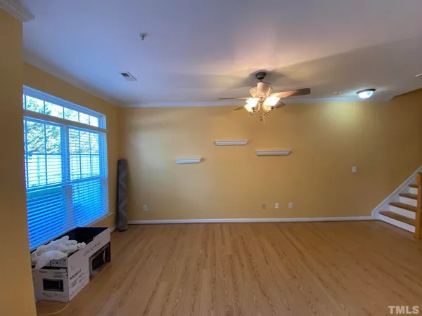 a view of a livingroom with a ceiling fan and window