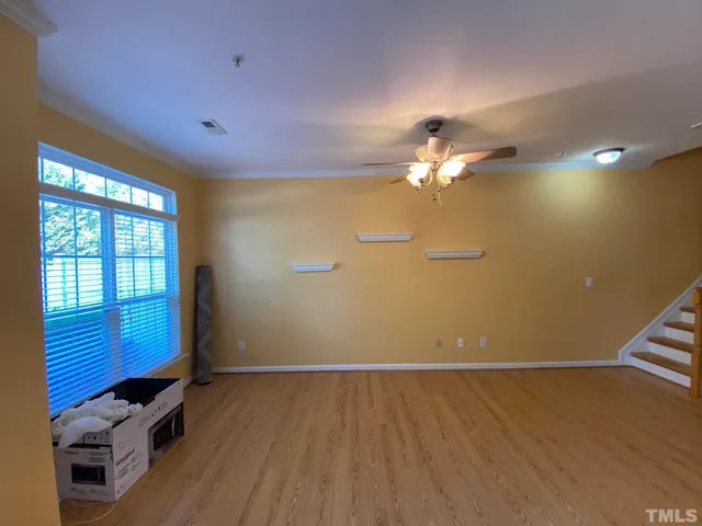 a view of a livingroom with a ceiling fan and window