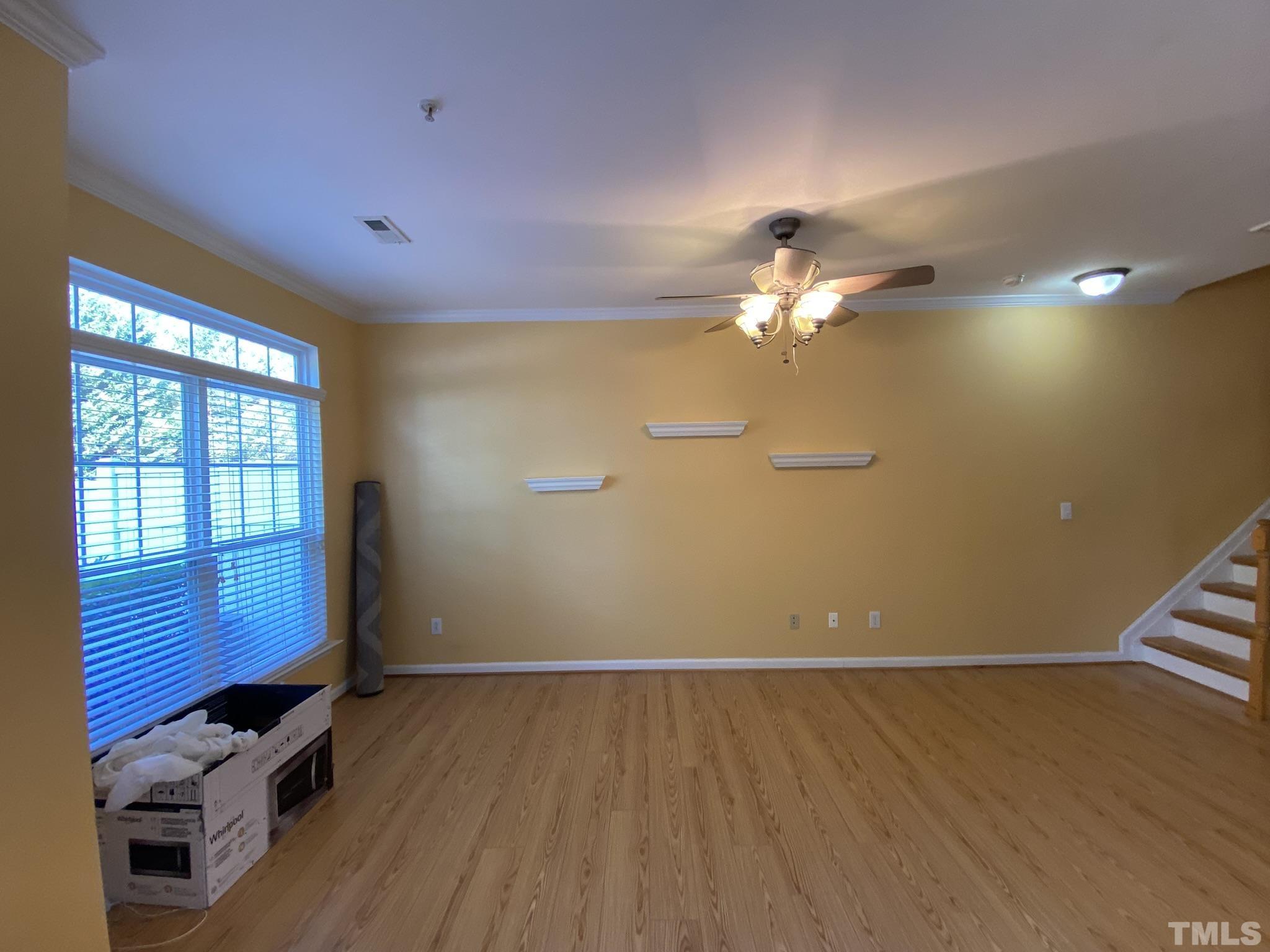 2220 Raven Road, Unit 101 Raleigh, NC 27614 - Photo 4 of 26 a view of a livingroom with a ceiling fan and window