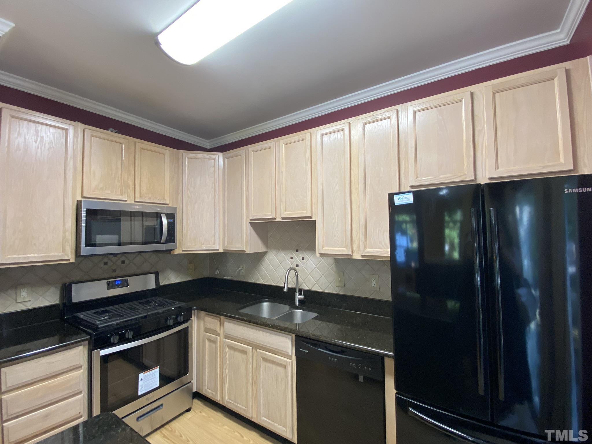 2220 Raven Road, Unit 101 Raleigh, NC 27614 - Photo 7 of 26 a kitchen with granite countertop a refrigerator stove and sink