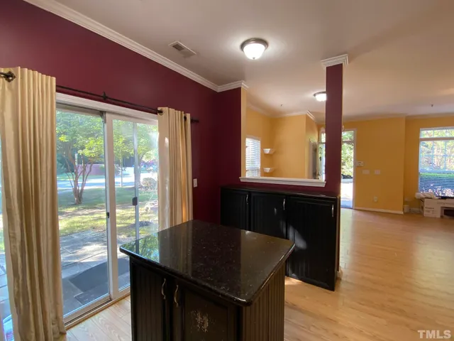 a kitchen with kitchen island granite countertop a sink and a granite counter top