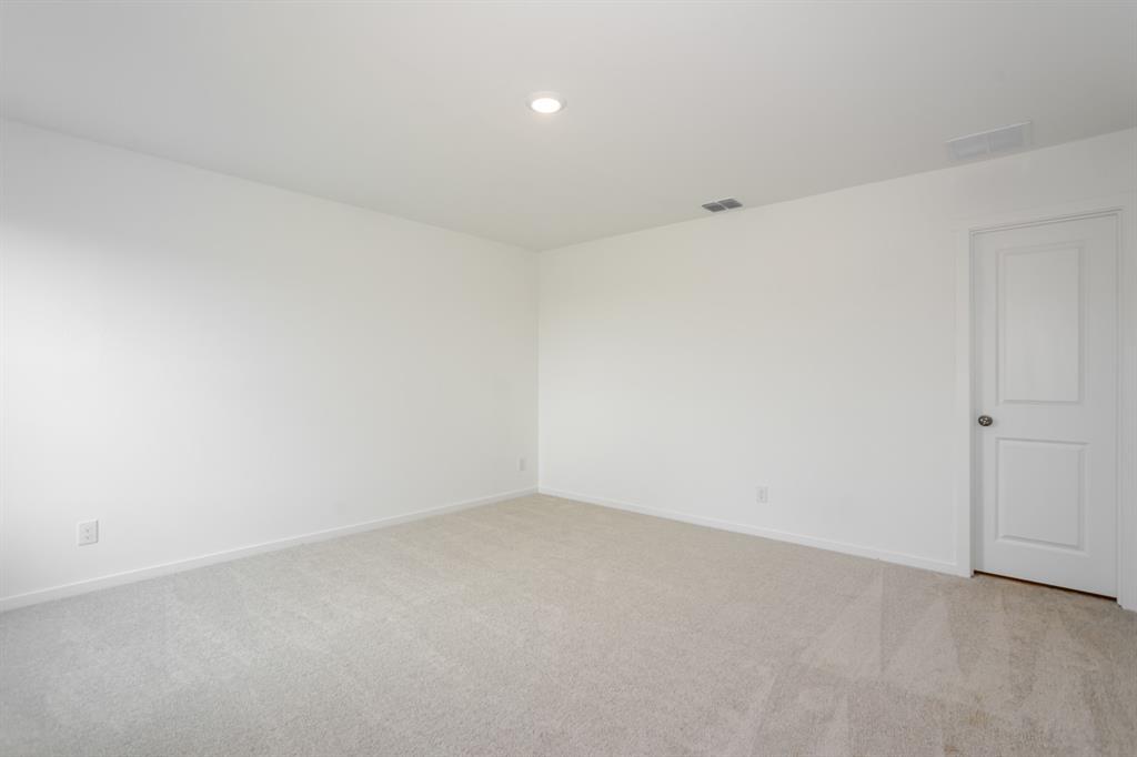 1419 Merlin Blf Street Forney, TX 75126 - Photo 14 of 24 Spacious room featuring light-toned carpeting, white painted walls, and a recessed ceiling light