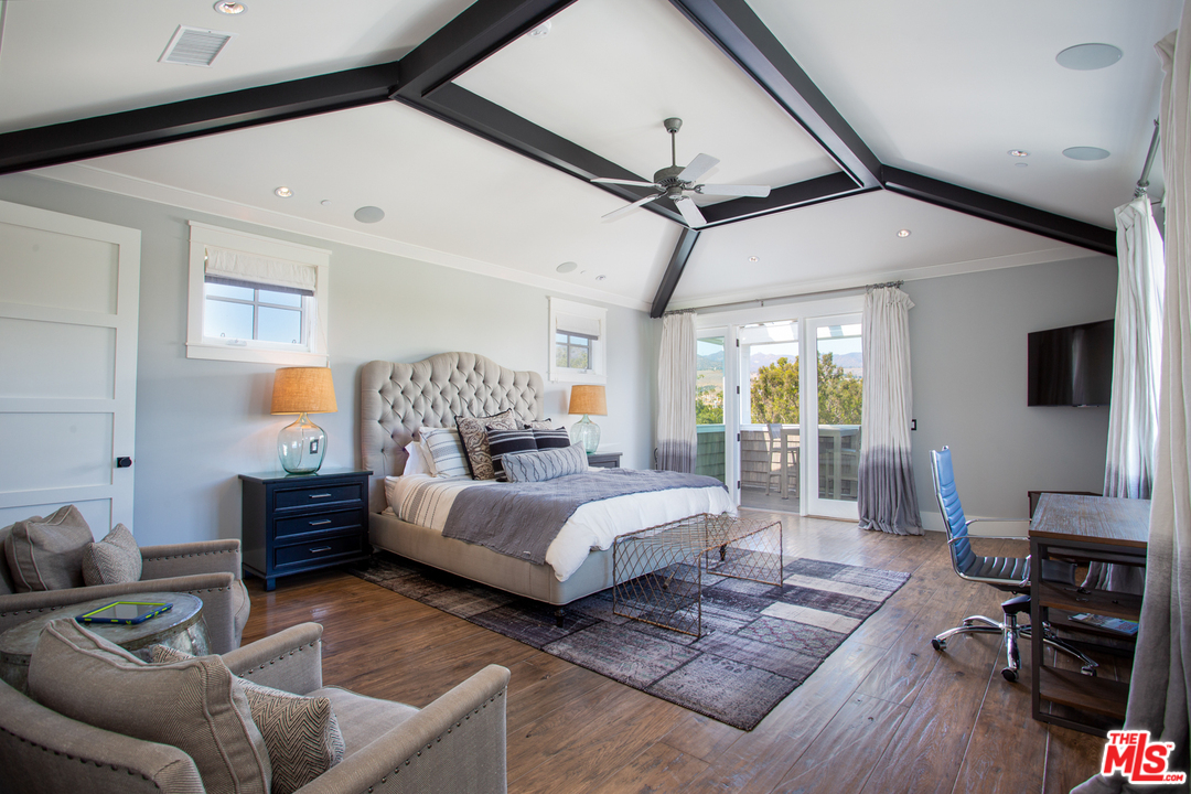 6692 Wildlife Road Malibu, CA 90265 - Photo 18 of 37 a bedroom with furniture and wooden floor