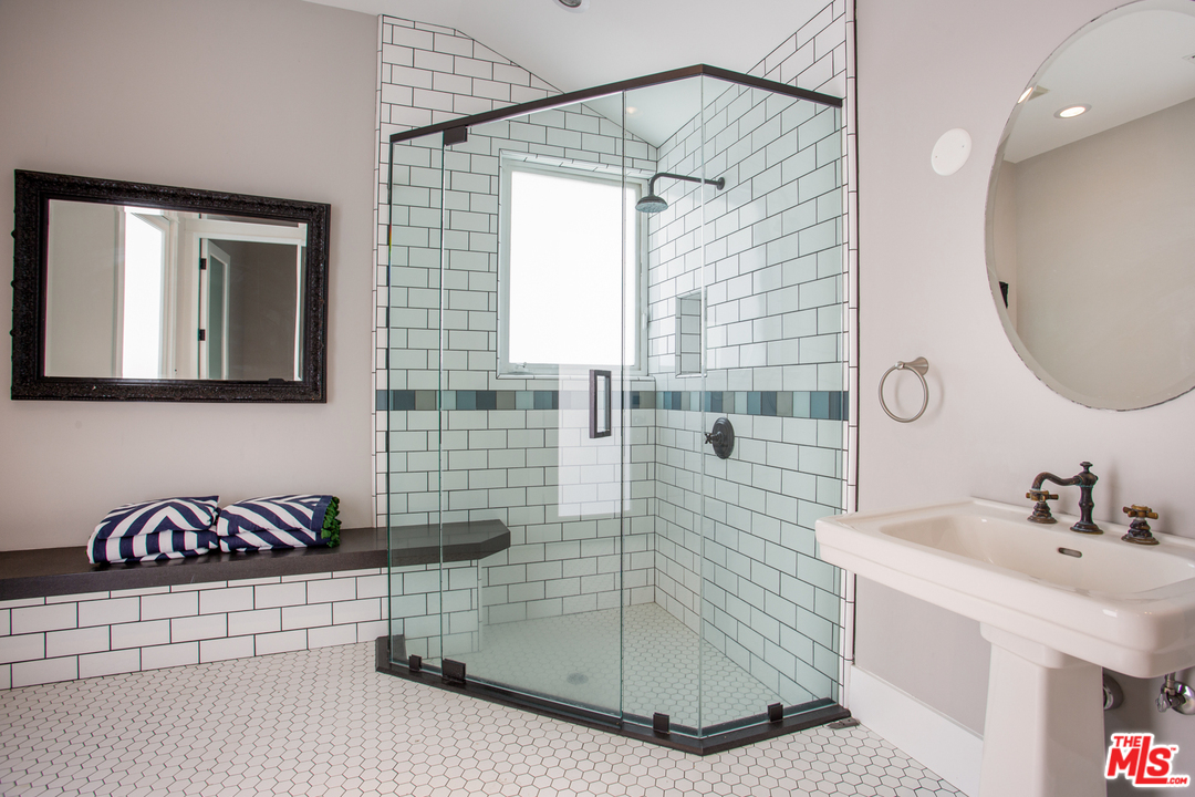 6692 Wildlife Road Malibu, CA 90265 - Photo 29 of 37 a bathroom with a sink a mirror and shower