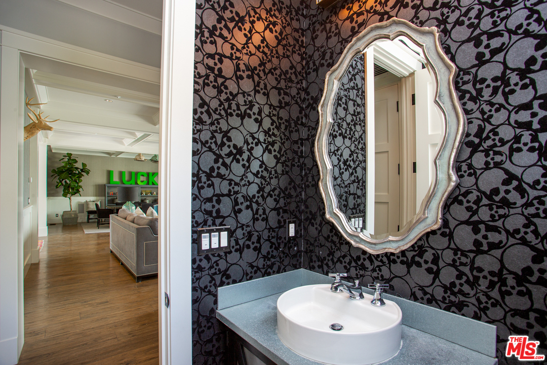 6692 Wildlife Road Malibu, CA 90265 - Photo 9 of 37 a bathroom with a sink mirror and vanity