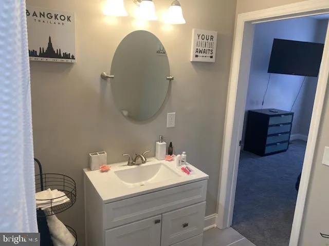 a bathroom with a sink toilet and mirror