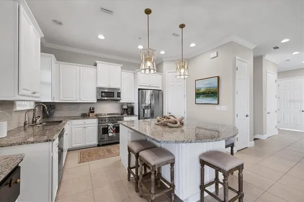a kitchen with stainless steel appliances granite countertop a sink stove and cabinets