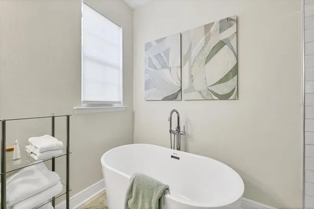 a bathroom with a granite countertop sink toilet a mirror and shower
