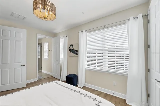 a bedroom with a bed a dresser and a window