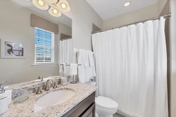 a view of a balcony with chairs and wooden floor