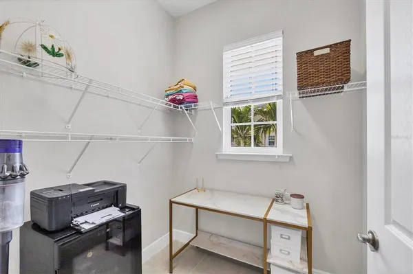 a balcony with furniture and floor to ceiling window