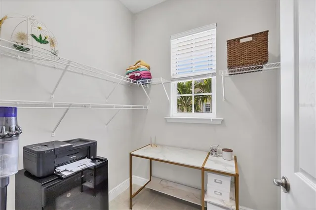 a balcony with furniture and floor to ceiling window