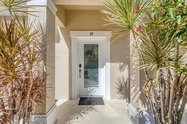 a bedroom with a large window and a potted plant